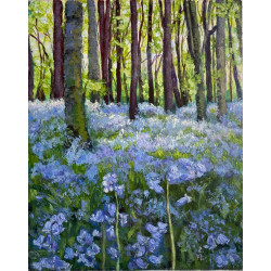 Spring forest with bluebells in sunlight